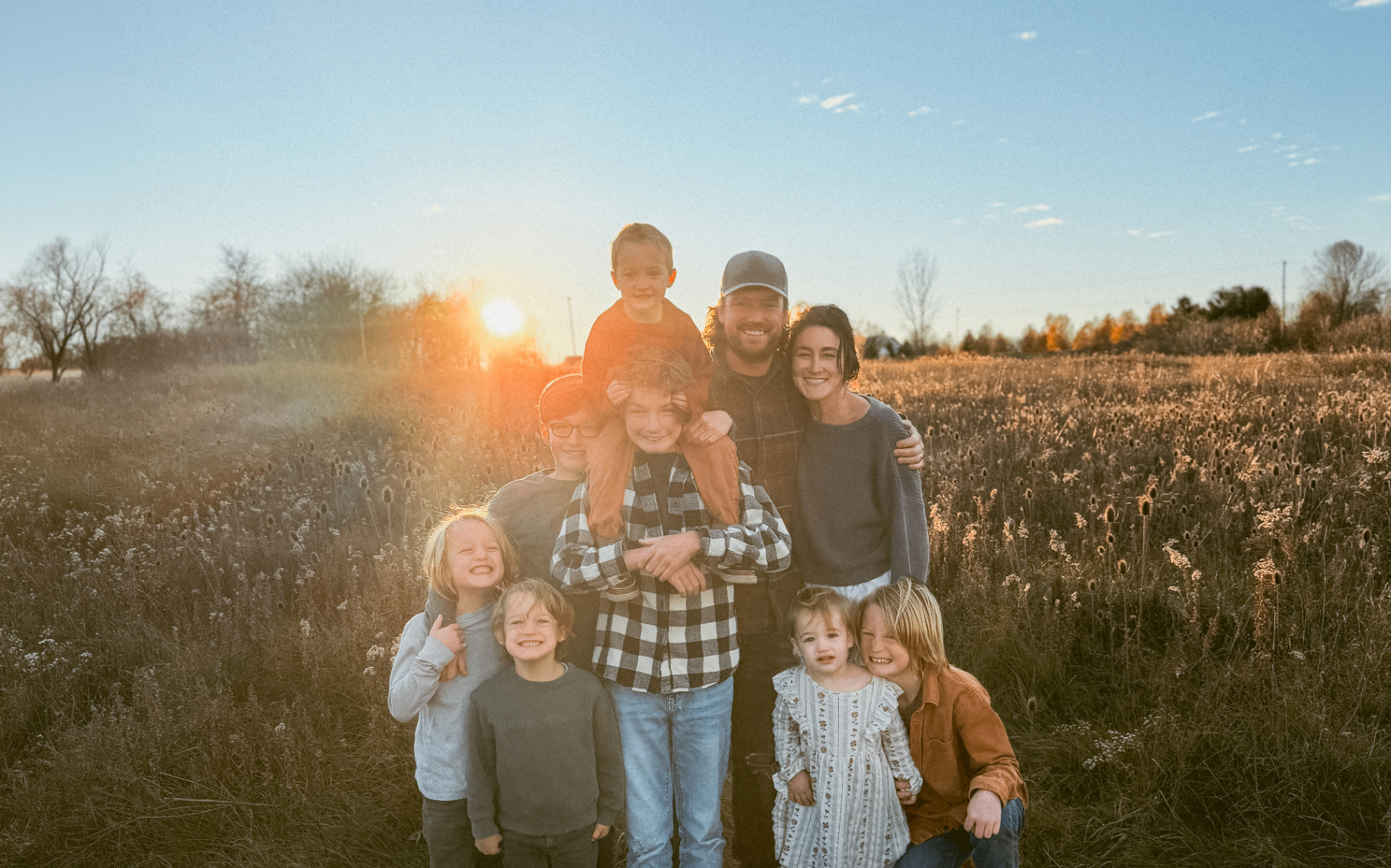 Tyler Joldersma with his family in a Michigan field at sunset